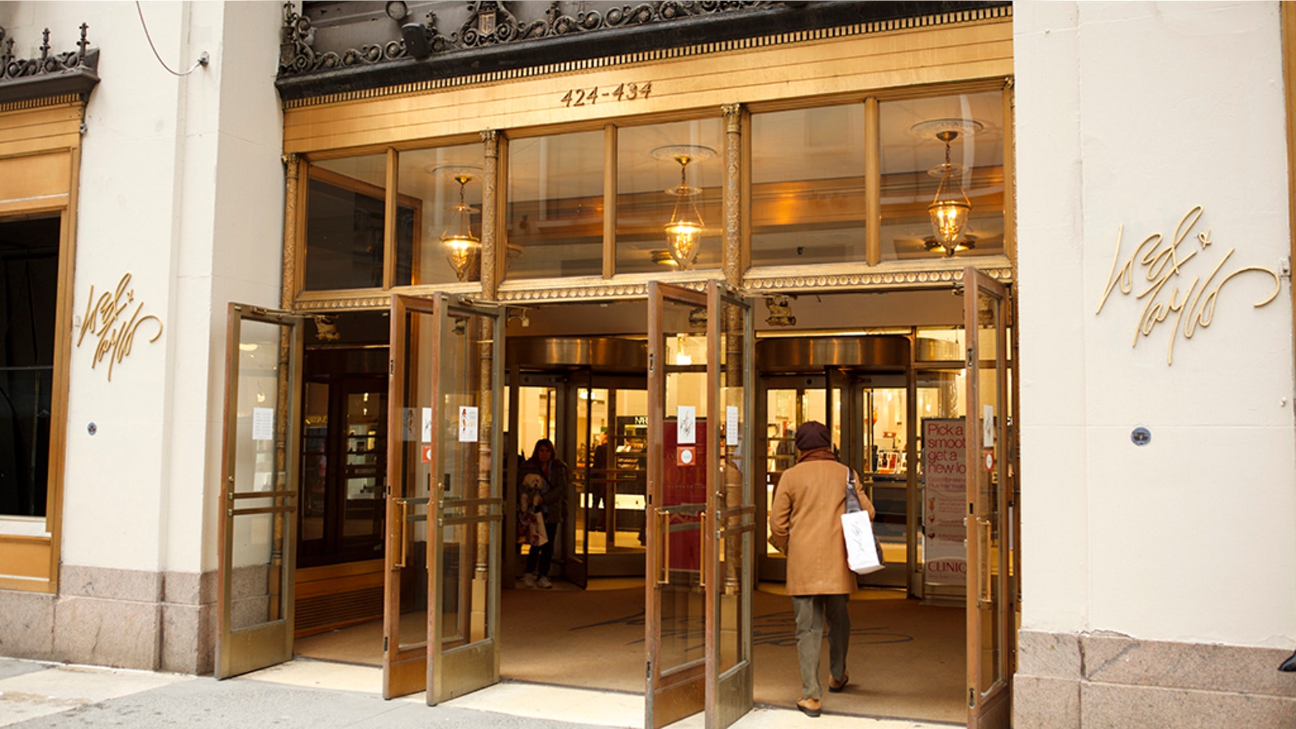 New York, New York, USA - March 14, 2011: The entrance to the well known Lord and Taylor flagship department store on fifth avenue in Manhattan. A woman is seen entering through the exterior doors. The Lord and Taylor stores date back to the 1800's.