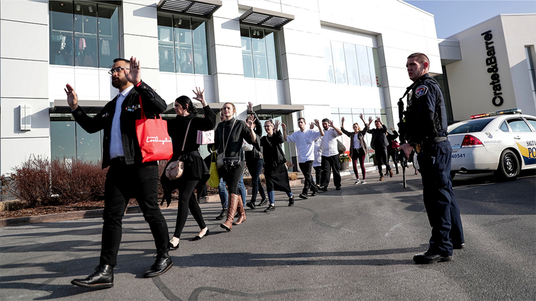 People evacuate after a reported shooting at Fashion Place Mall in Murray, Utah on Sunday, Jan. 13, 2019. (Spenser Heaps/The Deseret News via AP)