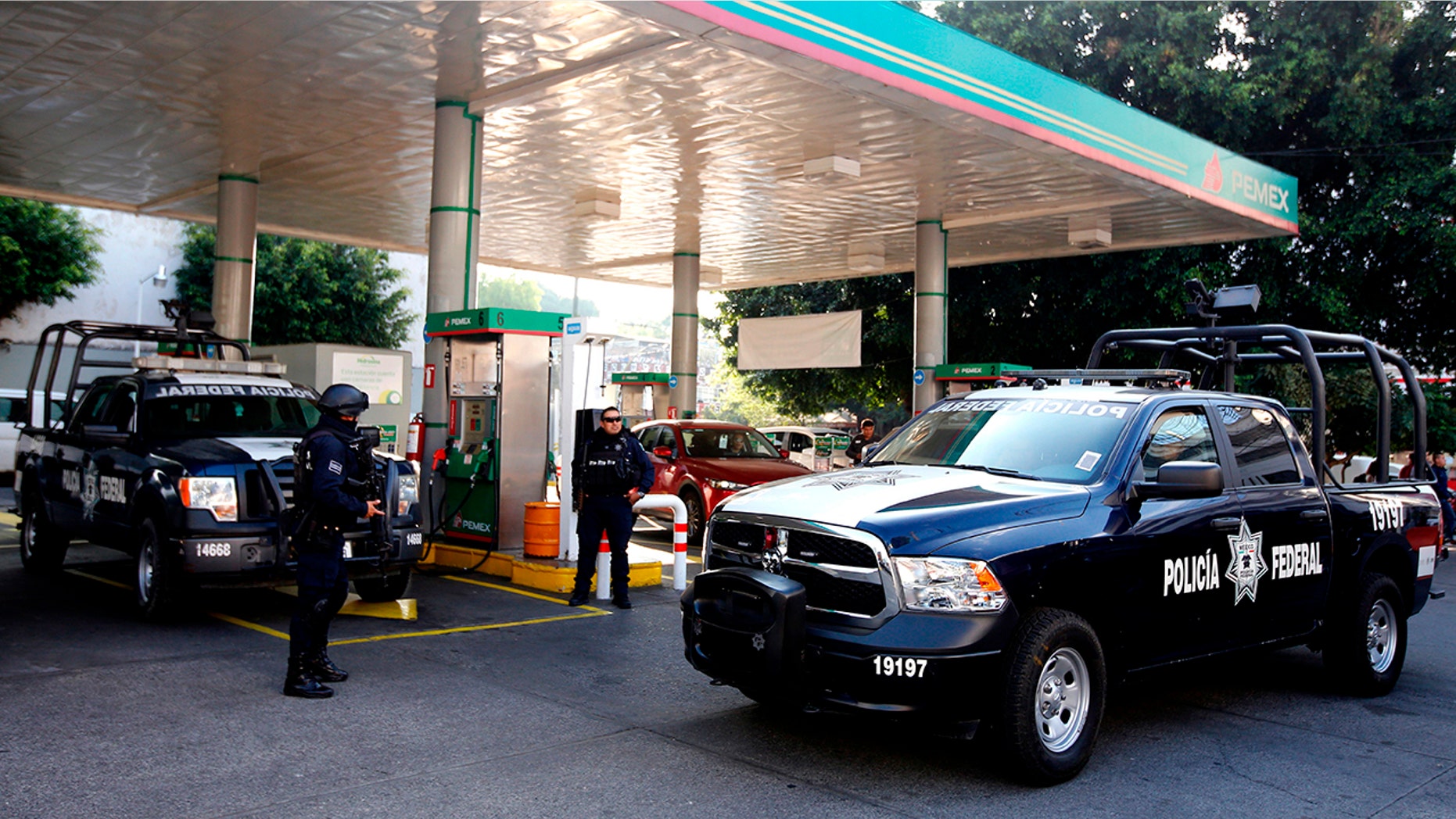 Federal police officers stand guard at a gas station in Guadalajara, Jalisco State, Mexico, on January 18, 2019. Mexican investigators opened a record number of murder cases the year prior, statistics show.