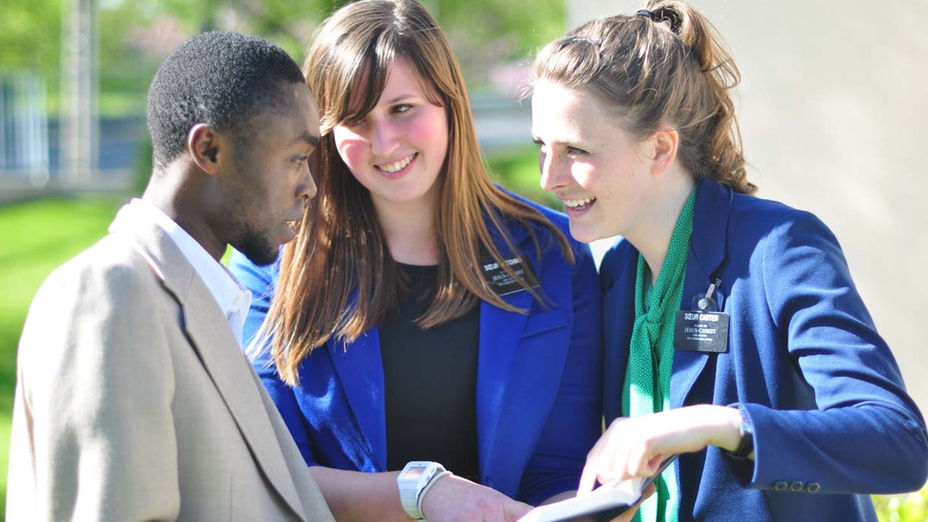 Sister missionaries teaching a young man in Lyon, France.