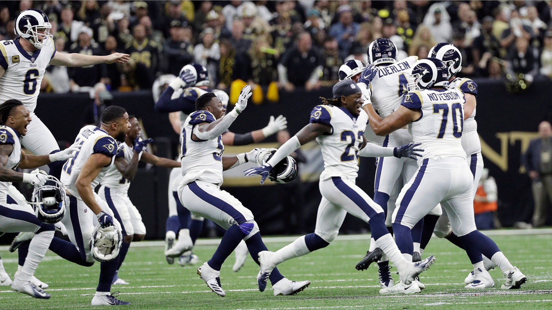 Los Angeles Rams players celebrate after overtime of the NFL football NFC championship game against the New Orleans Saints, Sunday, Jan. 20, 2019, in New Orleans. (AP Photo/David J. Phillip)