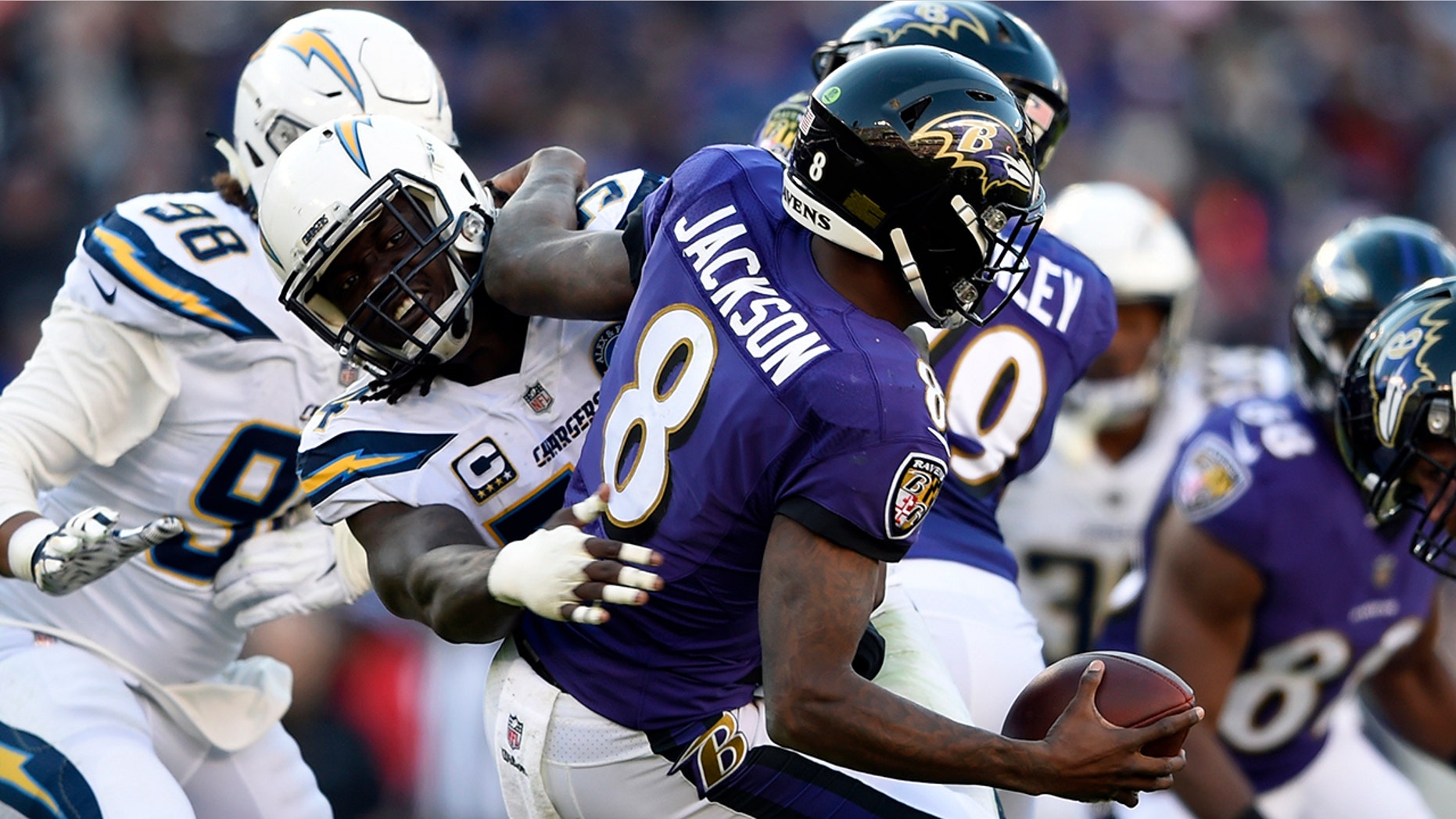 Baltimore Ravens quarterback Lamar Jackson (8) is sacked by Los Angeles Chargers defensive end Melvin Ingram in the second half of an NFL wild card playoff football game, Sunday, Jan. 6, 2019, in Baltimore.