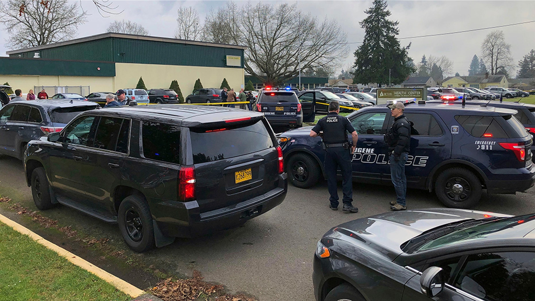Police officers work the scene where a suspect was shot at a Cascade Middle School in Eugene, Oregon, on Friday. (Chris Pietsch/The Register-Guard via AP)