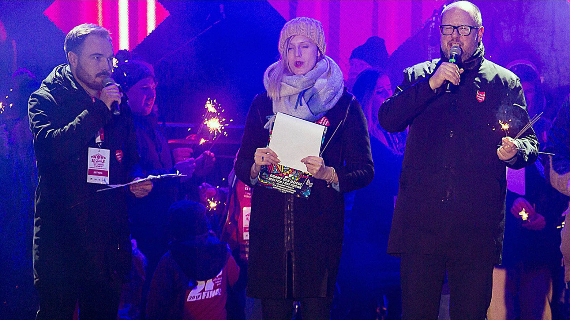 Gdansk Mayor Pawel Adamowicz, far right, speaks to an audience shortly before he was stabbed in Gdansk, Poland, on Sunday, Jan. 13, 2019. Adamowicz was taken to a hospital in very serious condition after the attack and underwent surgery. (AP Photo/Anna Rezulak/KFP) POLAND AUT