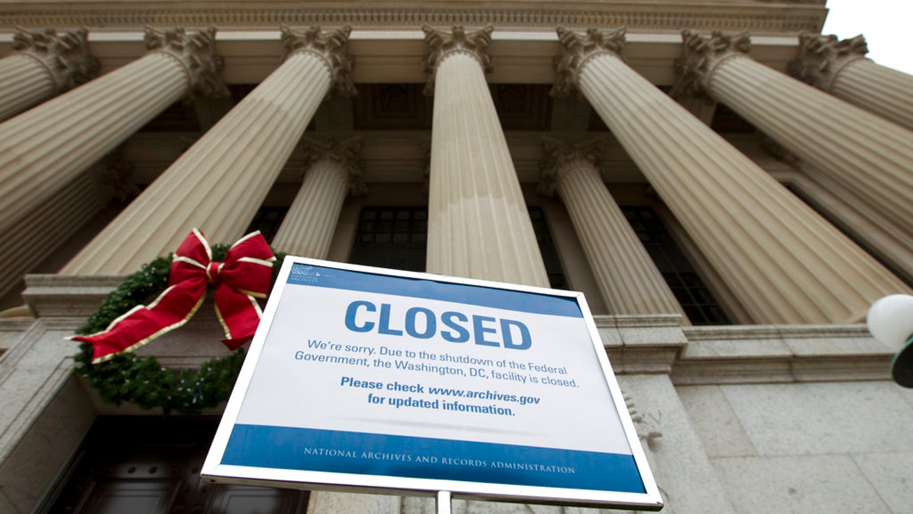 A closed sign is displayed at The National Archives entrance in Washington, Tuesday, Jan. 1, 2019, as a partial government shutdown stretches into its third week. A high-stakes move to reopen the government will be the first big battle between Nancy Pelosi and President Donald Trump as Democrats come into control of the House. (AP Photo/Jose Luis Magana)