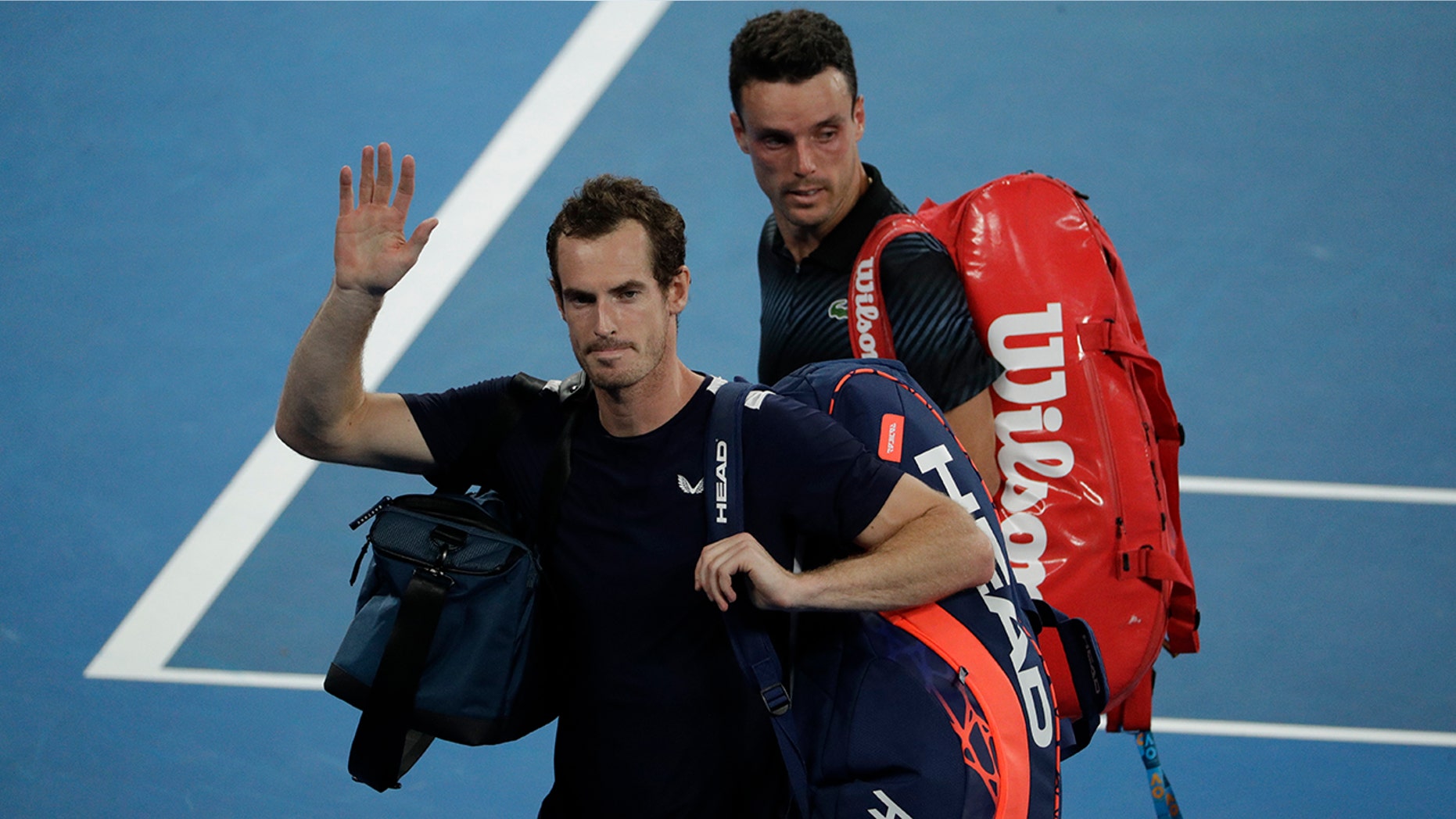 Britain's Andy Murray waves as he leaves the court following his first round loss to Spain's Roberto Bautista Agut at the Australian Open tennis championships in Melbourne, Australia, Monday, Jan. 14, 2019.