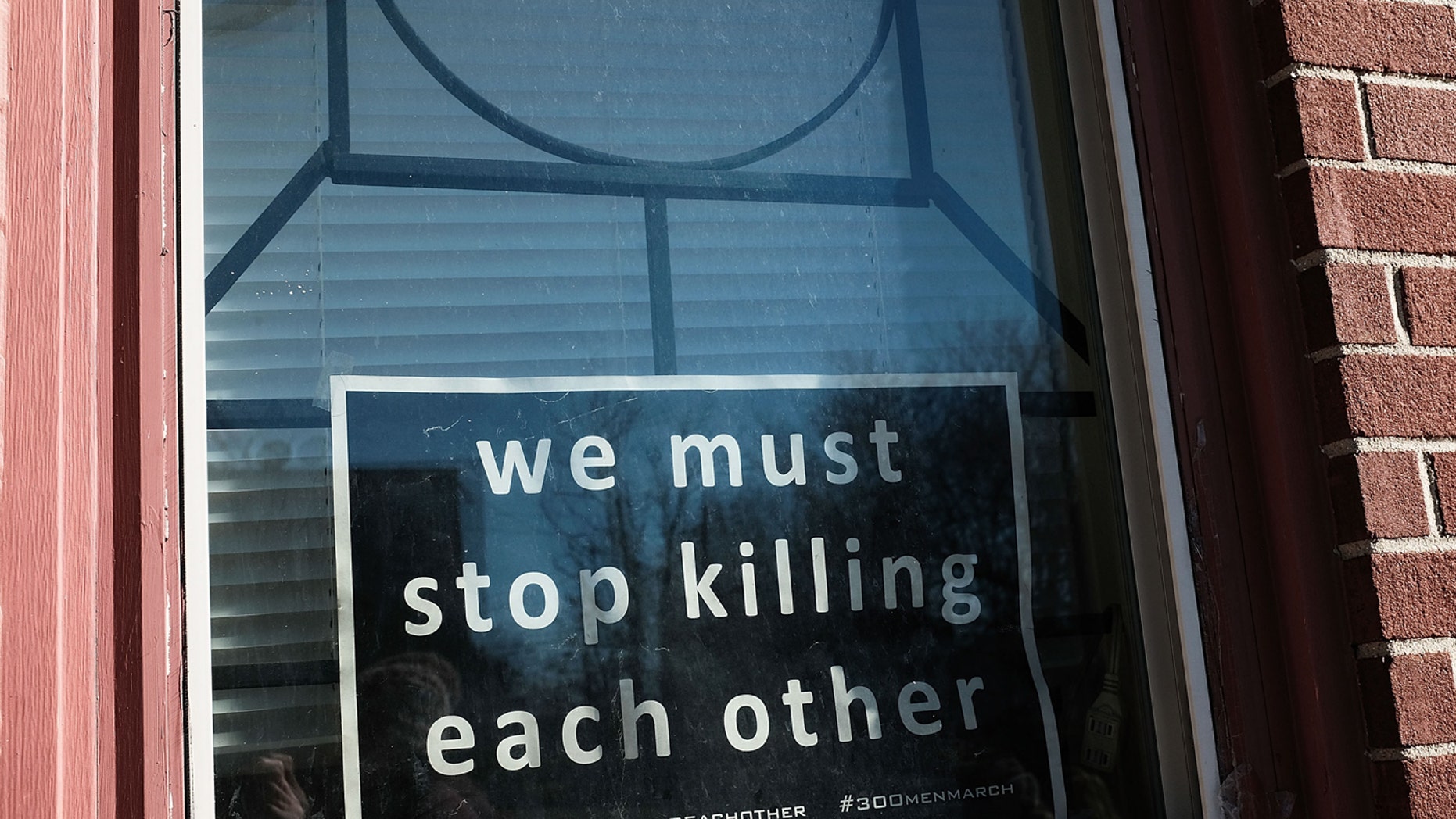 BALTIMORE, MD - FEBRUARY 03: A sign to end violence sits in a window in a neighborhood with a high murder rate on February 3, 2018 in Baltimore, Maryland. 