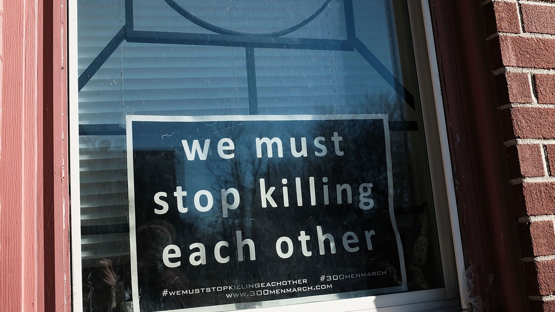 BALTIMORE, MD - FEBRUARY 03: A sign to end violence sits in a window in a neighborhood with a high murder rate on February 3, 2018 in Baltimore, Maryland.