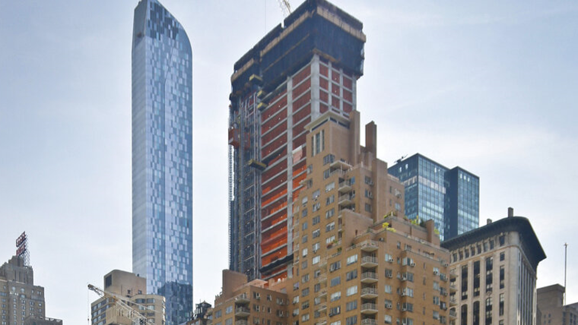 FILE: A crane sits on top of the ongoing construction of a new skyscraper at 220 Central Park South in New York.