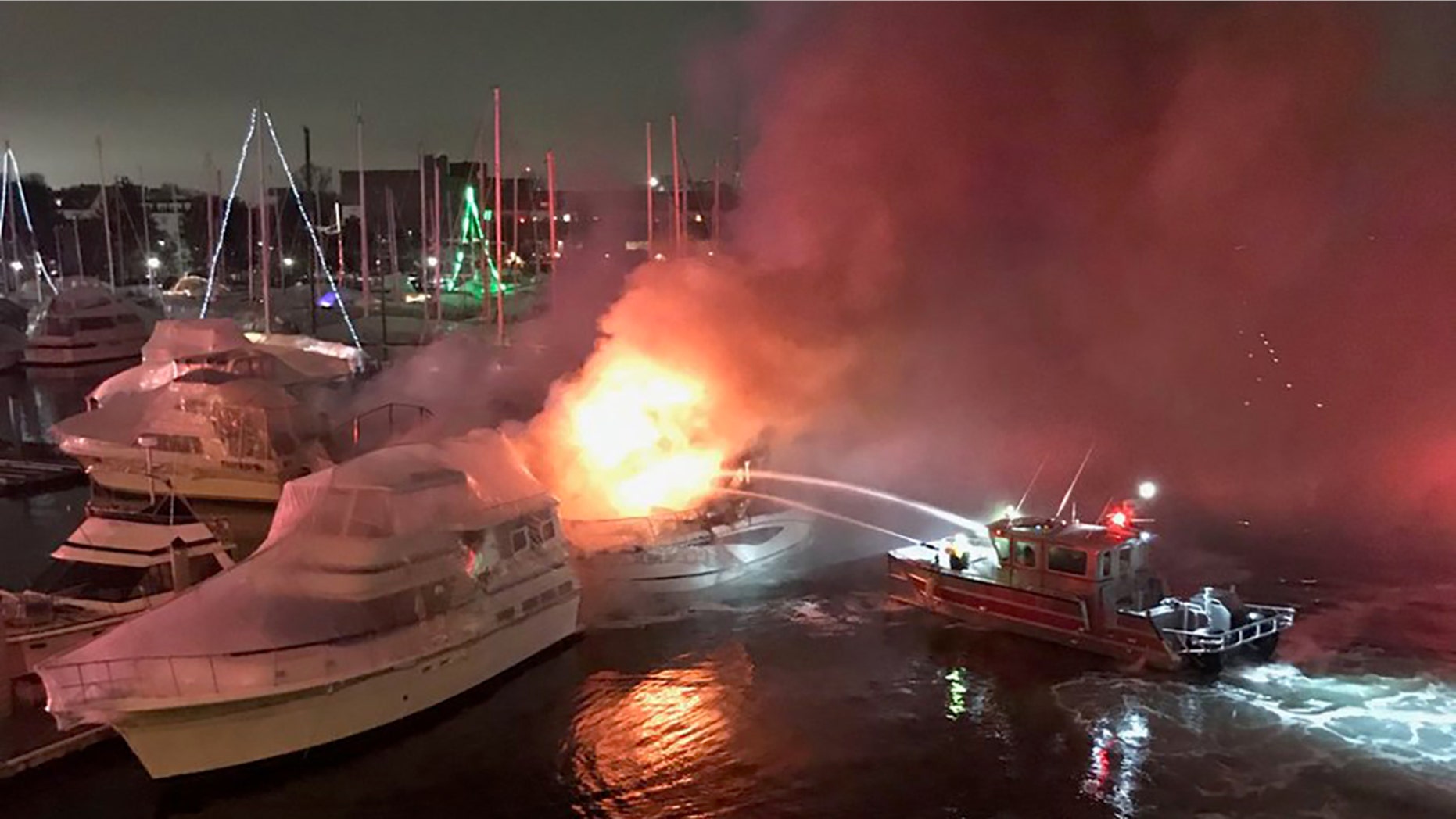 Two boats sank after three vessels caught fire late Tuesday at a Boston marina, officials said. (Boston Fire Department)