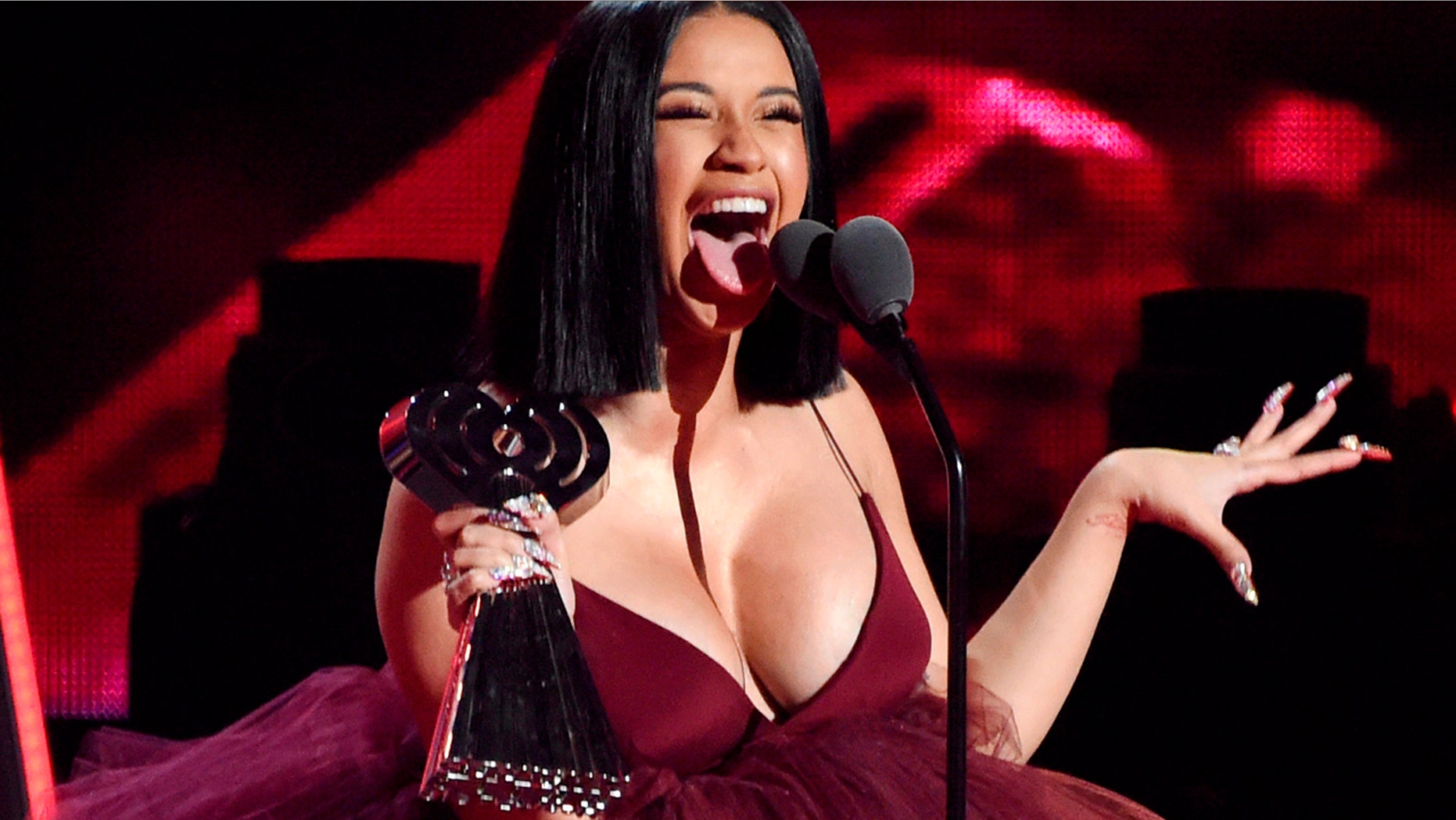 In this March 11, 2018, file photo, Cardi B accepts the Best New Artist award during the 2018 iHeartRadio Music Awards in Inglewood, Calif.
