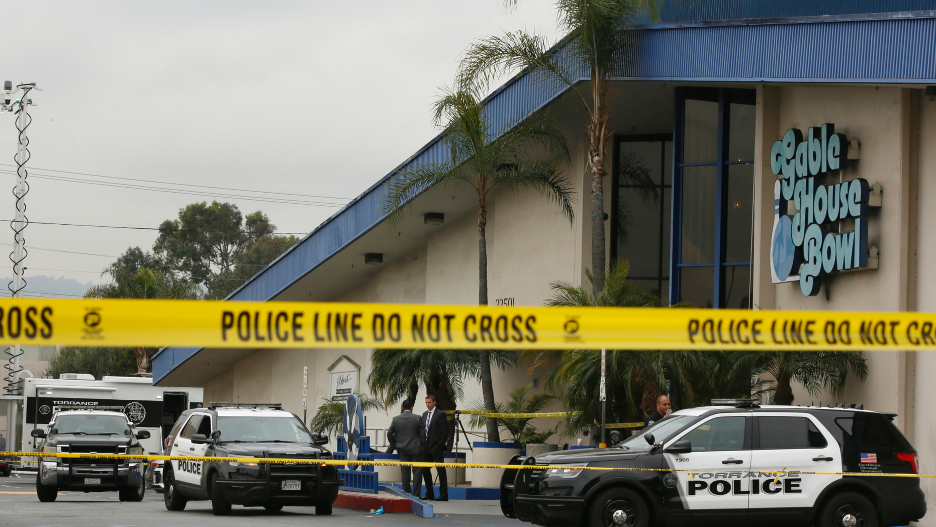 Police officers investigate a shooting incident with multiple fatalities at the Gable House Bowl in Torrance, Calif., Saturday, Jan. 5, 2019. A brawl between two large groups at the popular Los Angeles-area bowling alley and karaoke bar erupted into gunfire early Saturday according to witnesses. (AP Photo/Damian Dovarganes)