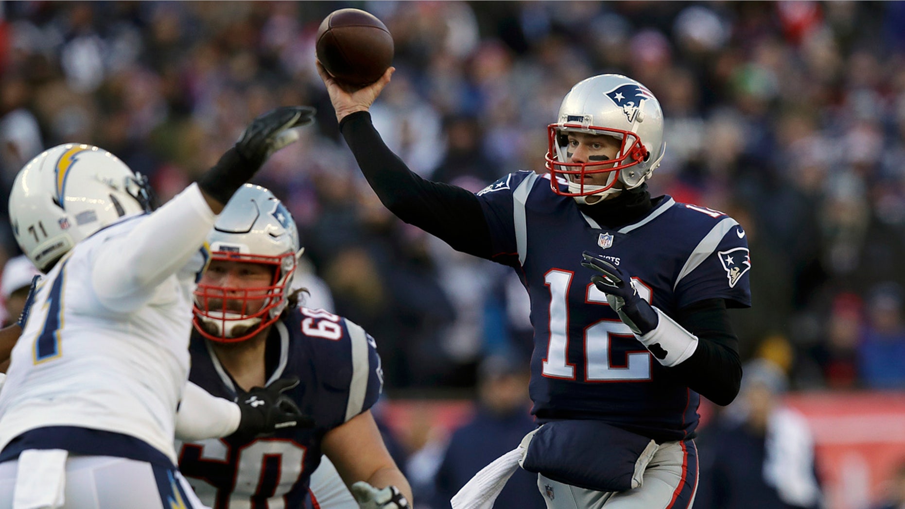 New England Patriots quarterback Tom Brady (12) passes under pressure from Los Angeles Chargers defensive end Damion Square (71) during the first half of an NFL divisional playoff football game, Sunday, Jan. 13, 2019, in Foxborough, Mass. (AP Photo/Charles Krupa)