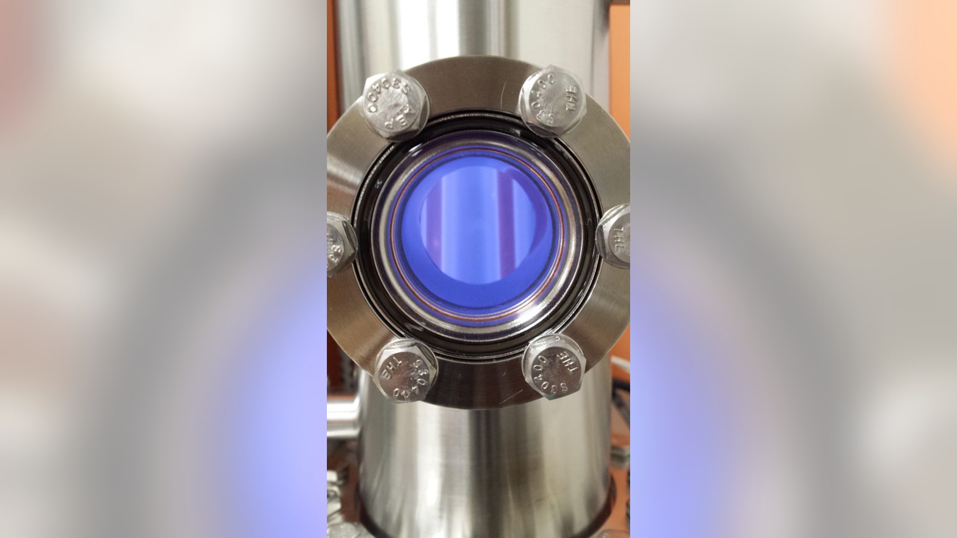 A CO2-rich planetary atmosphere exposed to a plasma discharge in Sarah Hörst’s lab. (Credit: Chao He)