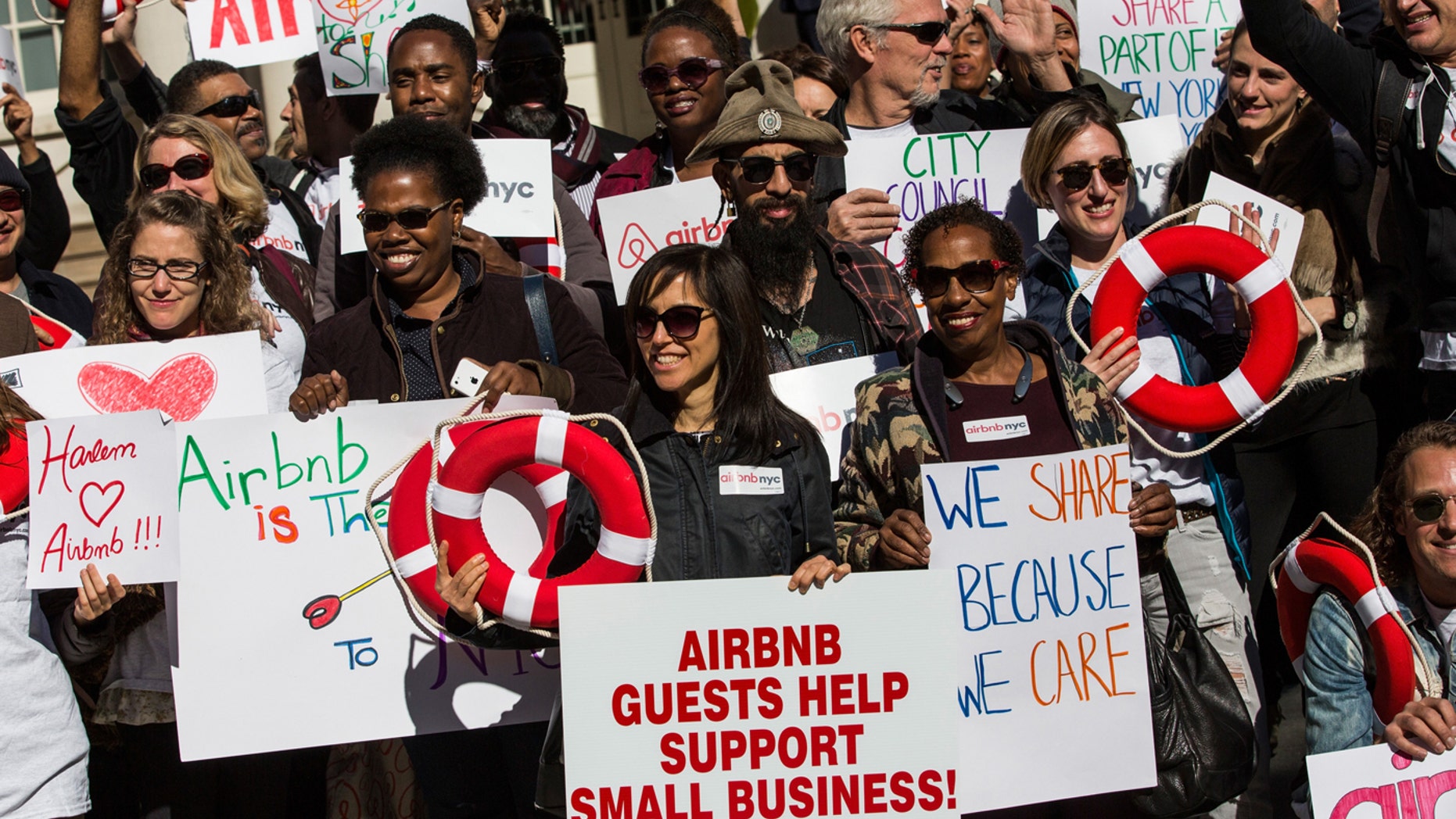 Supporters of Airbnb hold a rally on the steps of New York City Hall showing support for the company on October 30, 2015 in New York City. The New York City council is currently debating how to regulate the controversial company.