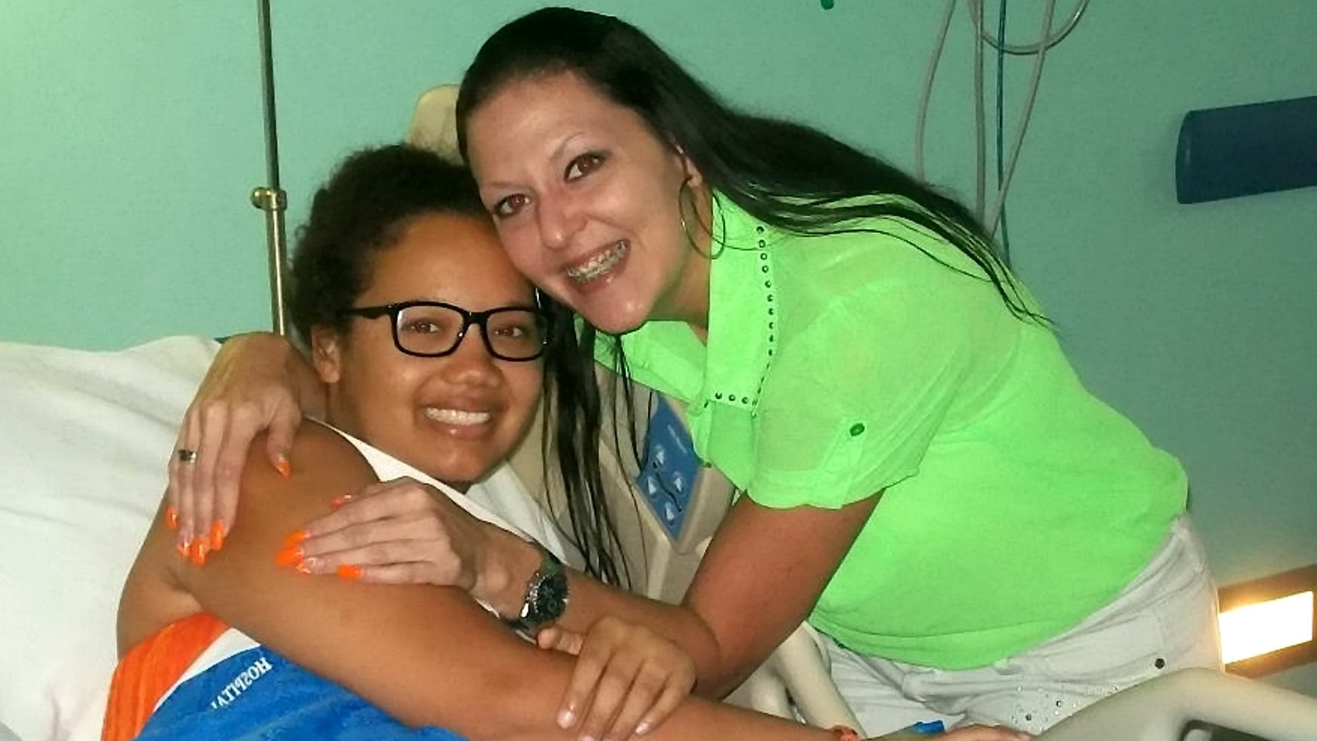 Gabrielle Newell, pictured with her aunt while in the hospital, said reconnecting with her faith in 2016 helped her find closure and forgiveness.