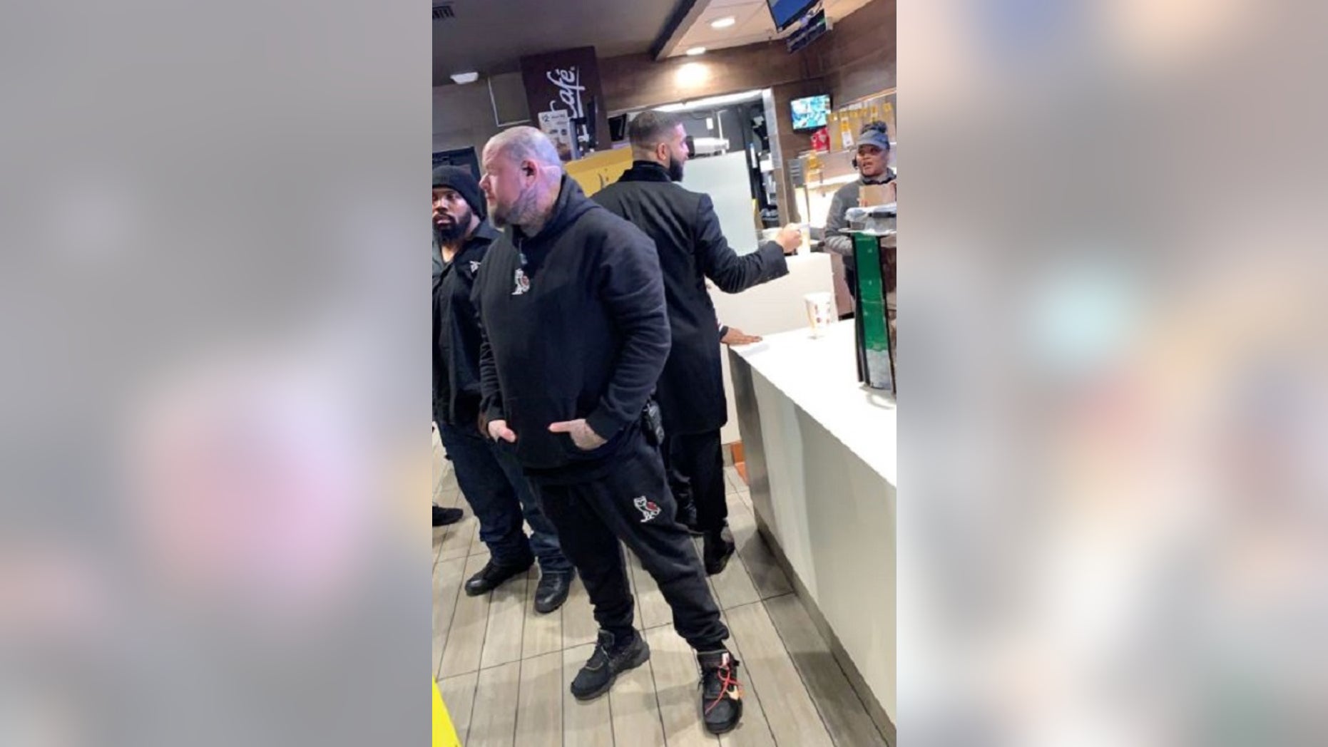 Drake appears to hand a hefty tip to McDonald's employees in Los Angeles last weekend.
