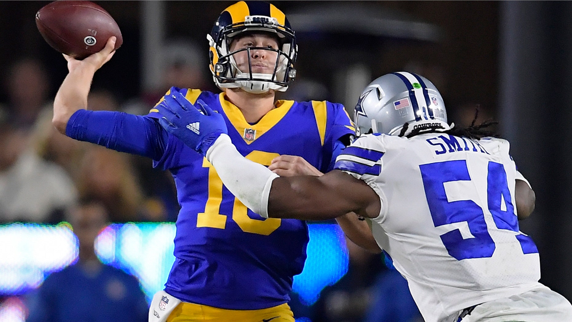 Los Angeles Rams quarterback Jared Goff passes under pressure from Dallas Cowboys middle linebacker Jaylon Smith during the first half in an NFL divisional football playoff game Saturday, Jan. 12, 2019, in Los Angeles. (Associated Press)