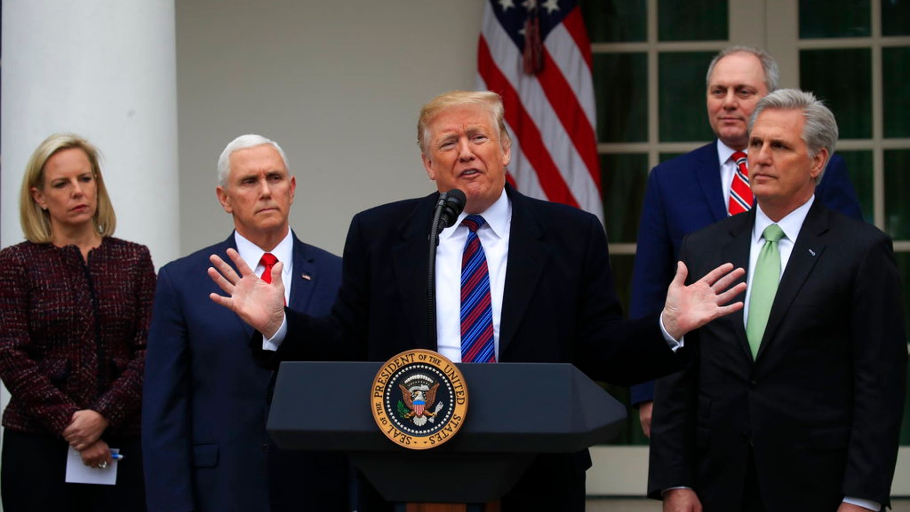President Donald Trump speaks in the Rose Garden of the White House in Washington, after a meeting with Congressional leaders on border security, as the government shutdown continues Friday, Jan. 4, 2019, as Homeland Security Secretary Kirstjen Nielsen, Vice President Mike Pence, House Minority Whip Steve Scalise of La., and House Minority Leader Kevin McCarthy of Calif., listen. (AP Photo/Manuel Balce Ceneta)