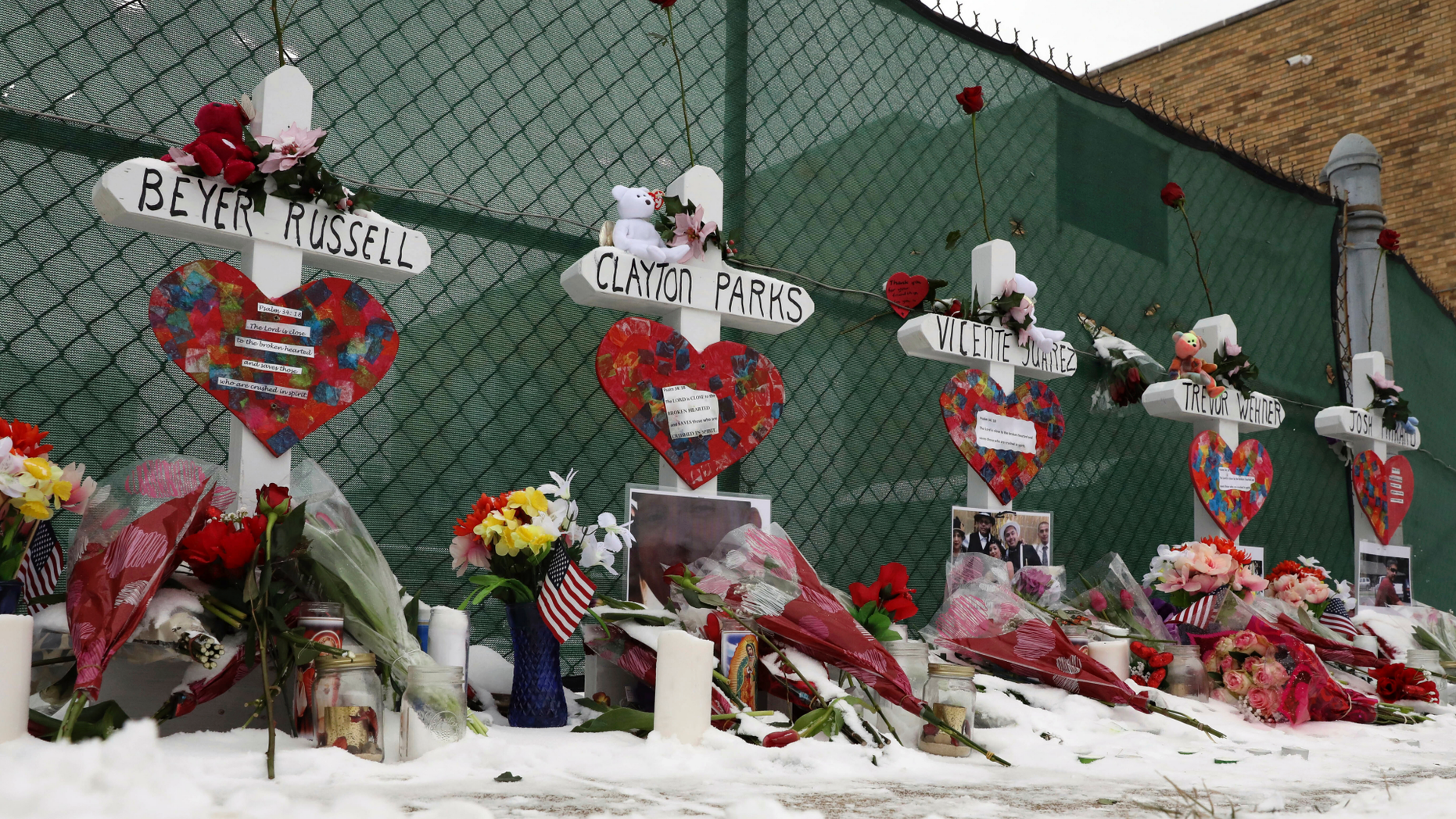 Crosses are placed for the victims of a mass shooting Sunday, Feb. 17, 2019, in Aurora, Ill., near Henry Pratt Co. manufacturing company where several were killed on Friday. Authorities say an initial background check five years ago failed to flag an out-of-state felony conviction that would have prevented a man from buying the gun he used in the mass shooting. (AP Photo/Nam Y. Huh)