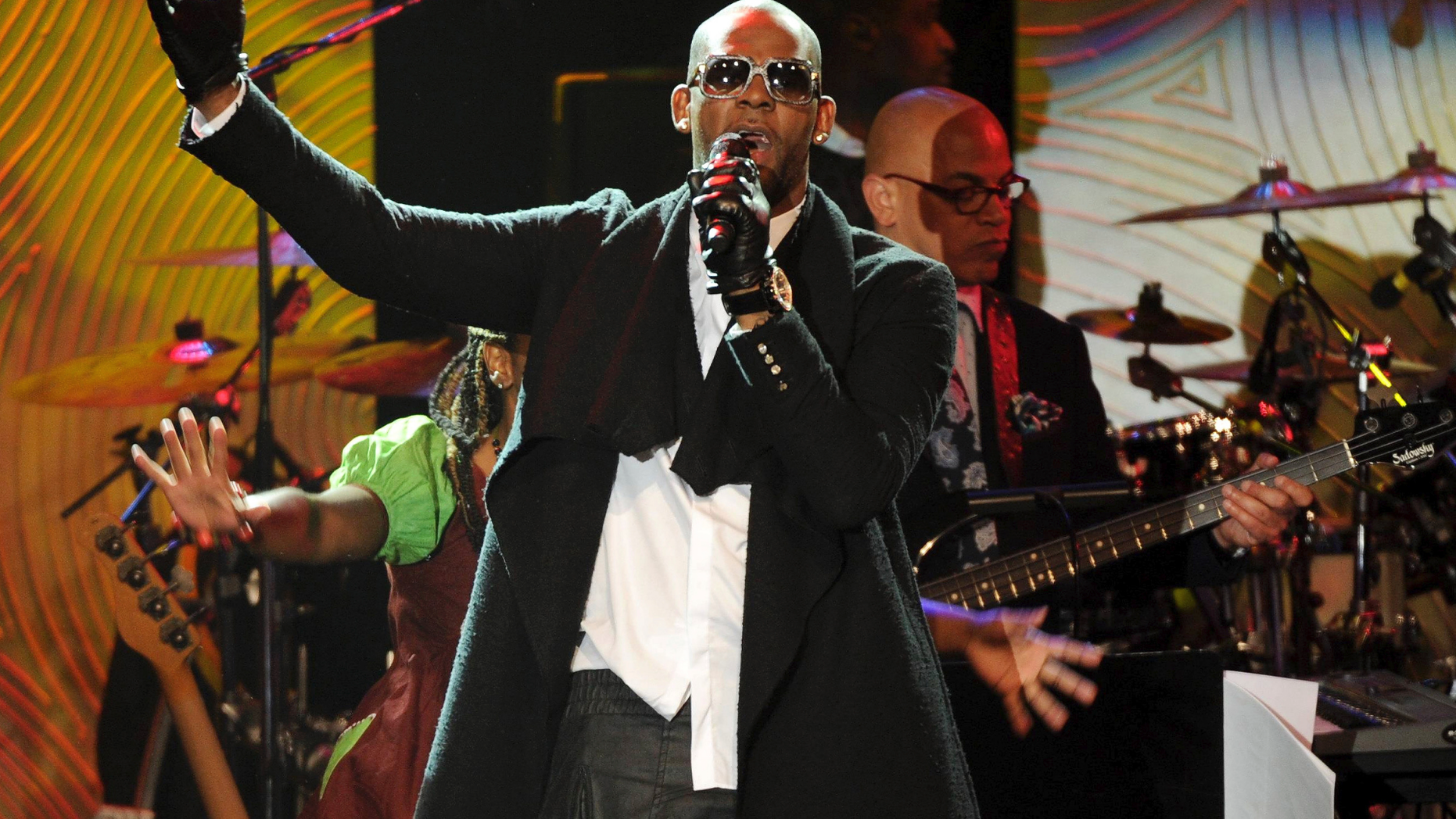 FILE - In this Jan. 25, 2014 file photo, recording artist R. Kelly performs at The 56th Annual Grammy Awards Salute to Industry Icons with Clive Davis in Beverly Hills, Calif. R. Kelly, the R&B star who has been trailed for decades by allegations that he violated underage girls and women and held some as virtual slaves, was charged Friday, Feb. 22, 2019, with aggravated sexual abuse involving four victims, including at least three between the ages of 13 and 17. (Photo by Frank Micelotta/Invision/AP, File)