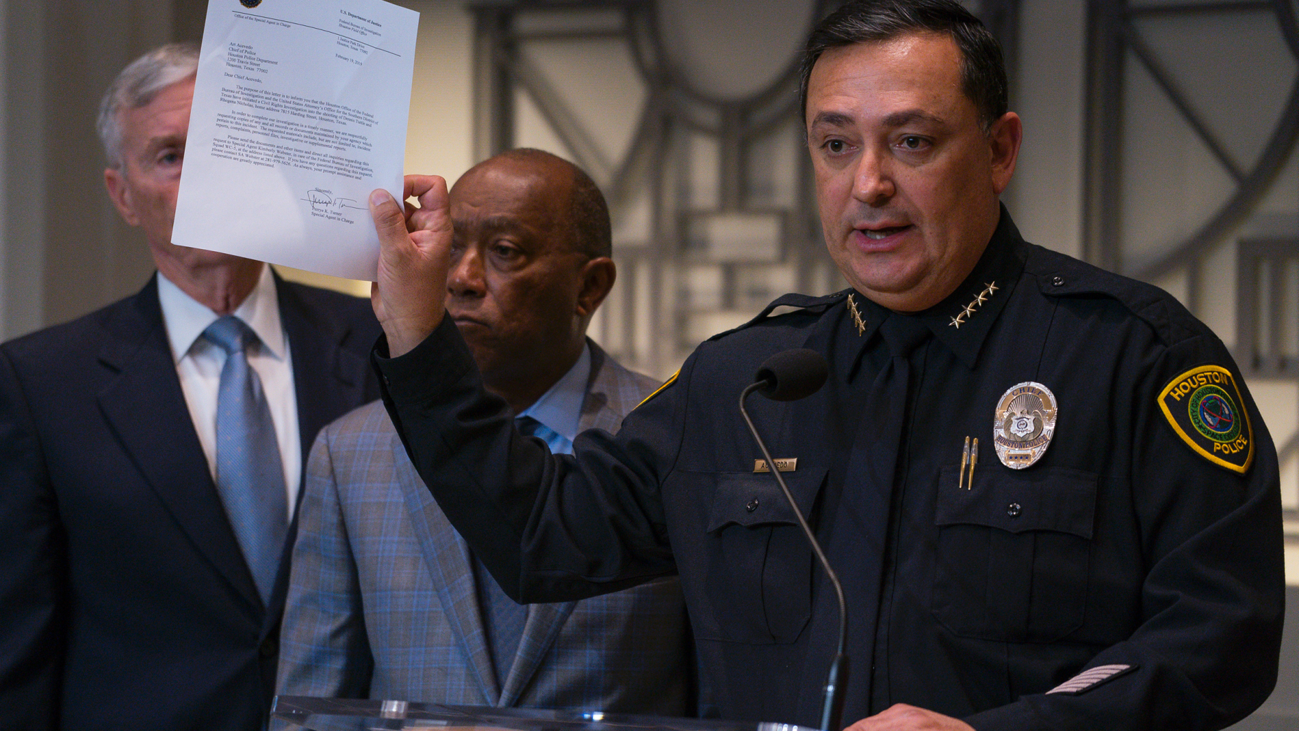 Houston Police Department Chief Art Acevedo holds up a letter from the FBI announcing the bureau's civil rights investigation related to the deaths of two people during the no-knock raid by narcotics officers that killed two people and injured five police officers last month, during a press conference from Houston City Hall, Wednesday, Feb. 20, 2019.