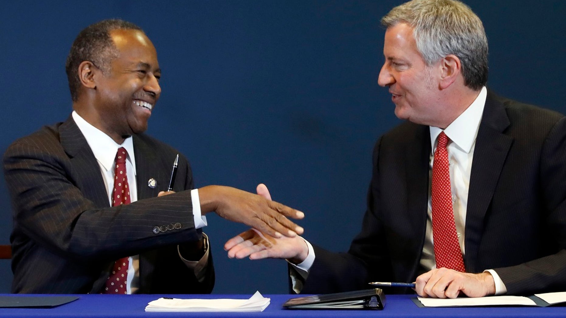 Housing and Urban Development Secretary Ben Carson, left, and New York Mayor Bill de Blasio shake hands after a ceremonial signing of an agreement for oversight of New York City's public housing system, in New York, Jan. 31, 2019. (Associated Press)