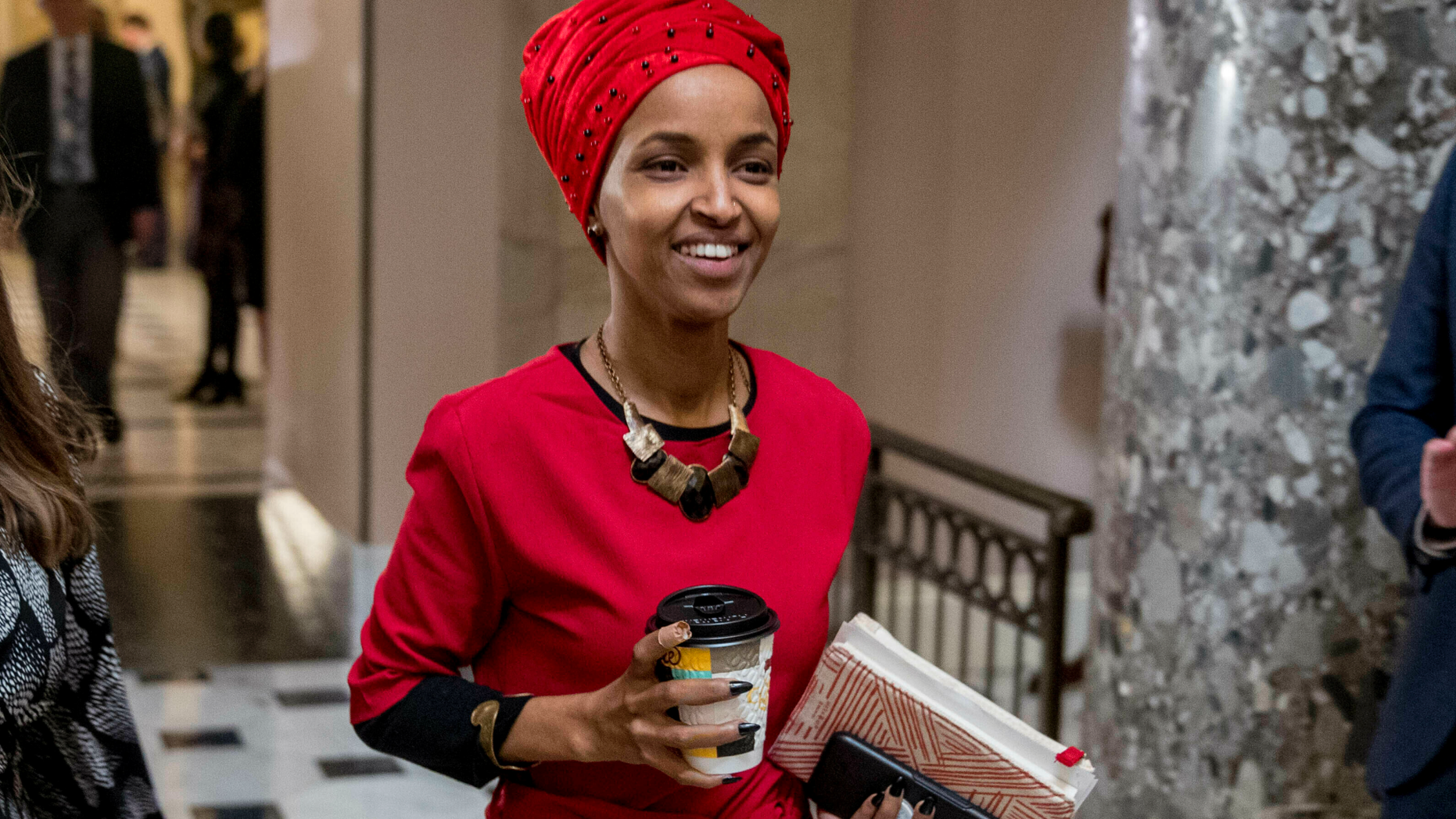 In this Jan. 16, 2019 file photo, Rep. Ilhan Omar, D-Minn., center, walks through the halls of the Capitol Building in Washington. (AP Photo/Andrew Harnik)