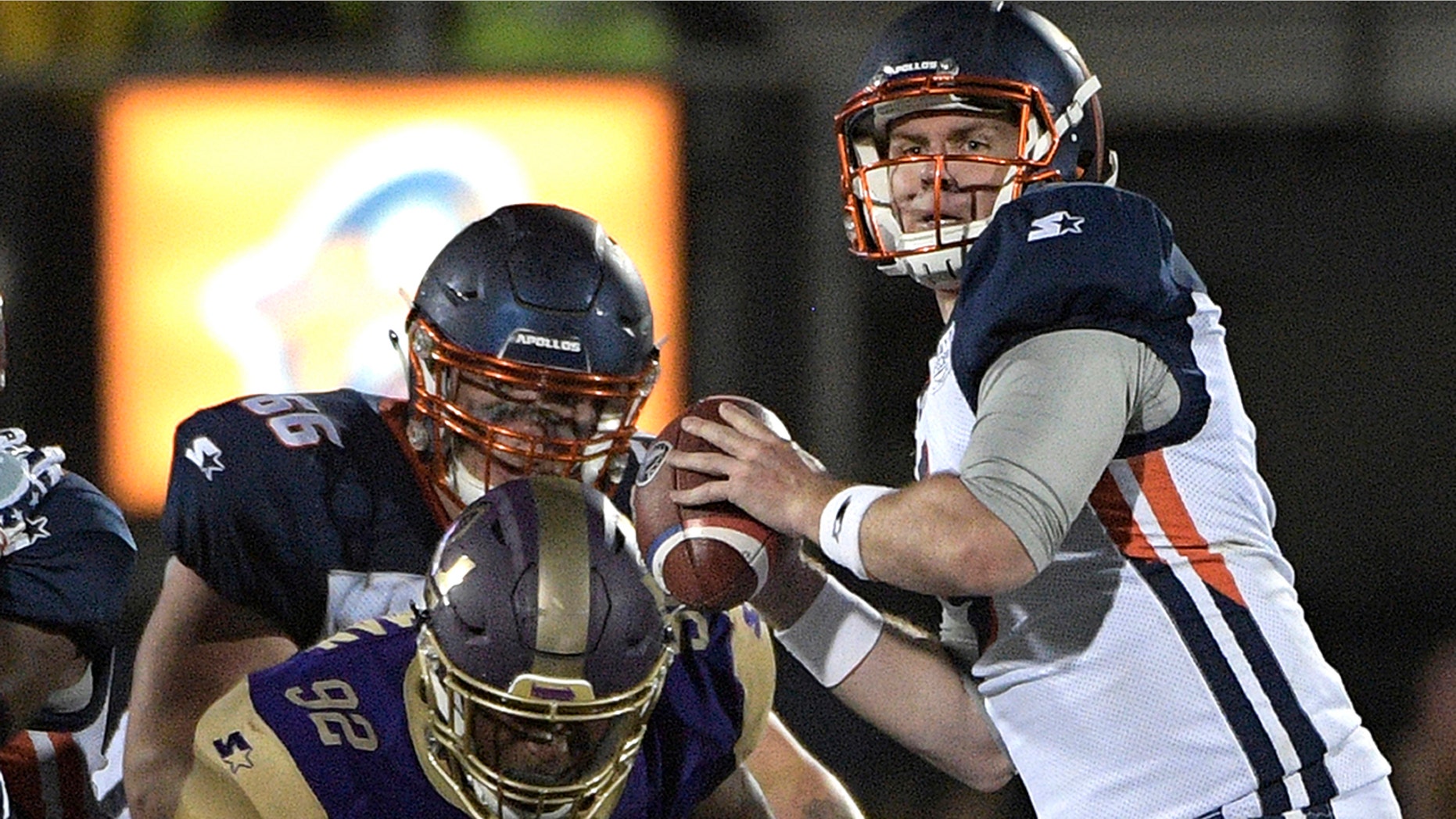 Quarterback Orlando Apollos sets Garrett Gilbert, right, to pass the Atlanta Legends linebacker KeShun Freeman (92) during the first half of the American Football game, Saturday, February 9, 2019, in Orlando, Fla. (Associated Press)
