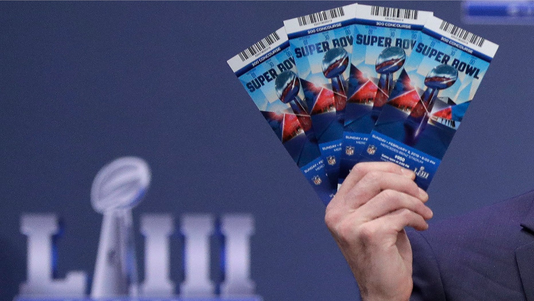 Michael, Buchwald, NFL senior counsel, legal, holds up Super Bowl LIII tickets as he explains the security features on the tickets during a news conference, Jan. 31, 2019, in Atlanta. (Associated Press)