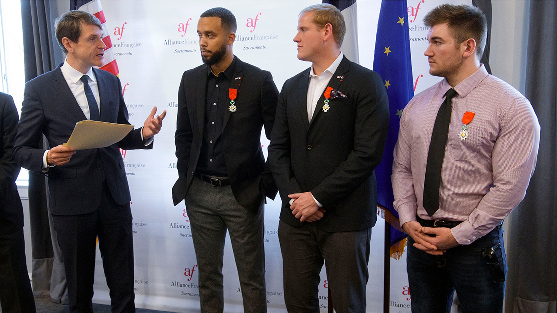 French Consul General Emmanuel Lebrun-Damiens, left, honors Spencer Stone, Anthony Sadler, and Alek Skarlatos during a French Naturalization Ceremony in Sacramento, Calif., Thursday, Jan. 31, 2019. The three men were heralded as heroes when they subdued an armed terrorist on a train in France in 2015. Today they were granted French citizenship. (AP Photo/Randall Benton)