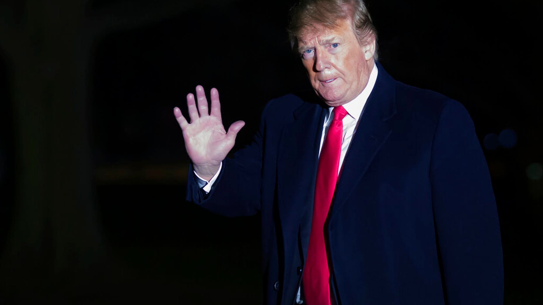President Donald Trump waves after stepping off Marine One on the South Lawn of the White House.
