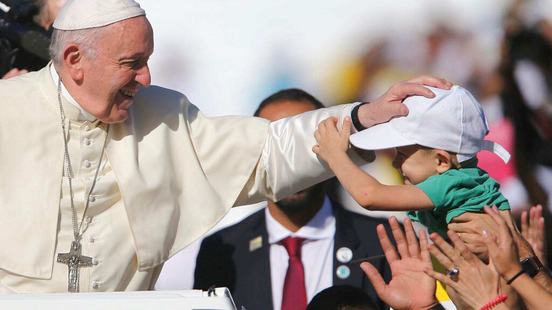 Pope Francis blesses a boy during a Mass at the Sheikh Zayed Sports City in Abu Dhabi, United Arab Emirates.