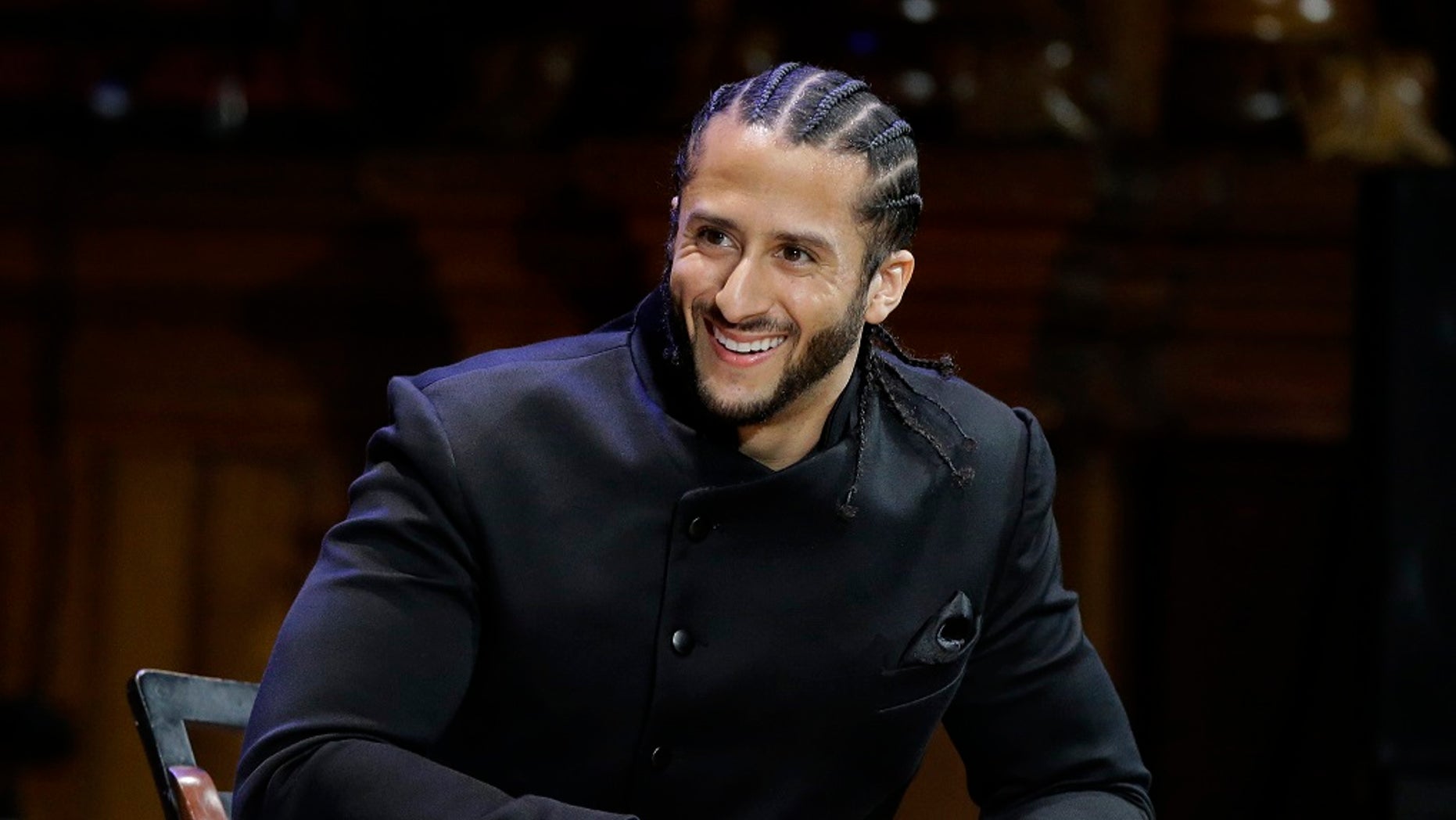 REPORT - In this October 11, 2018 photo, former NFL football quarterback Colin Kaepernick smiles on stage at W.E.B. Ceremonies of the Wood Medal at Harvard University, Cambridge, Mass. (AP Photo / Steven Senne, File)