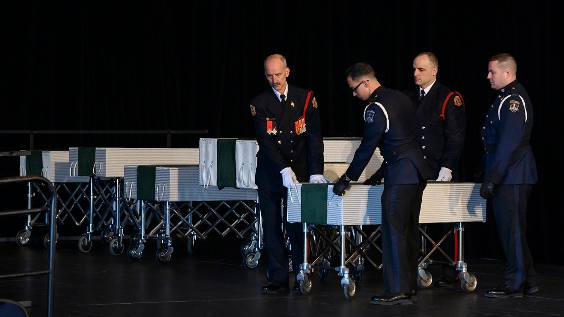 Members of the Halifax Fire and Police honor guard prepare to transport the caskets of the seven Barho children during the funeral for the Syrian refugees in Halifax, Nova Scotia, Canada, on Saturday, Feb. 23, 2019. (Darren Calabrese/The Canadian Press via AP)