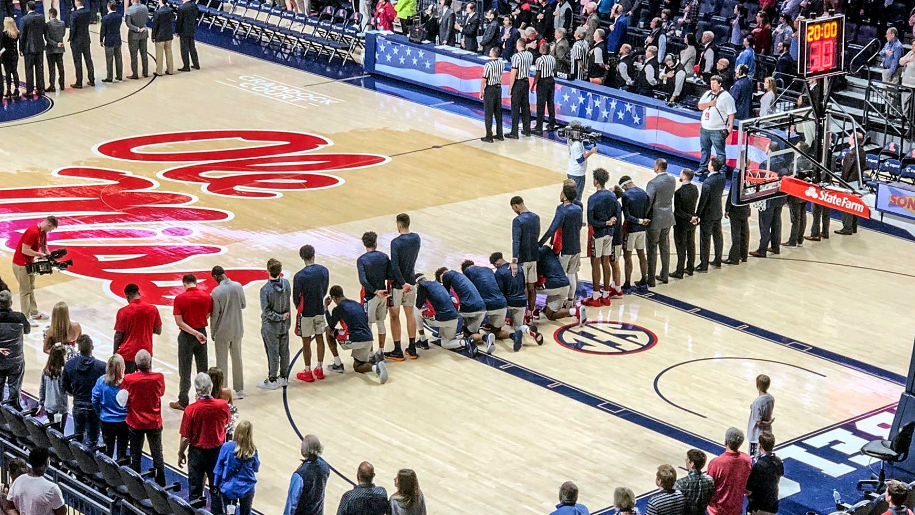 Six Mississippi basketball players kneel at the national anthem before a university basketball match against Georgia in Oxford on Saturday.