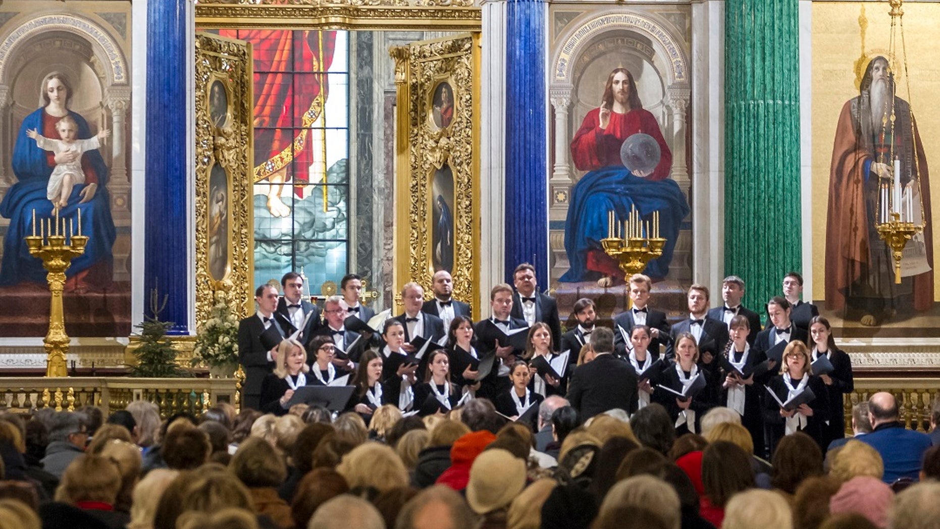 FILE 2018: Concert Choir performs at the St. Isaac's Cathedral in St. Petersburg, Russia. A choir in the Russian city of St. Petersburg has drawn criticism for performing a satirical song about firing a missile on the United States from a Soviet nuclear submarine. (Roman Pimenov, Interpress photo agency via AP)