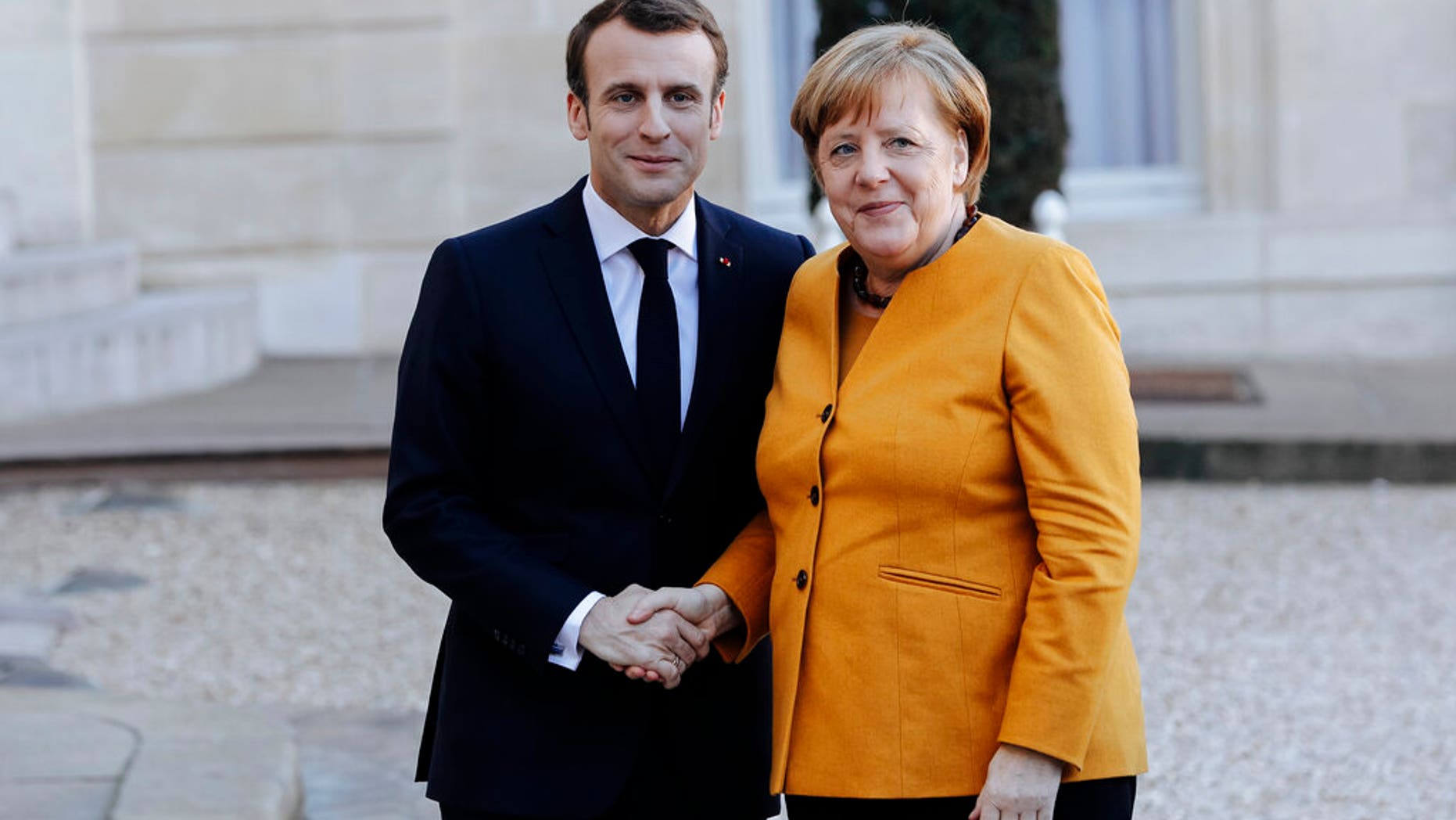 French President Emmanuel Macron, left, greets German Chancellor Angela Merkel prior to their meeting at the Elysee Palace in Paris, Wednesday, Feb. 27.