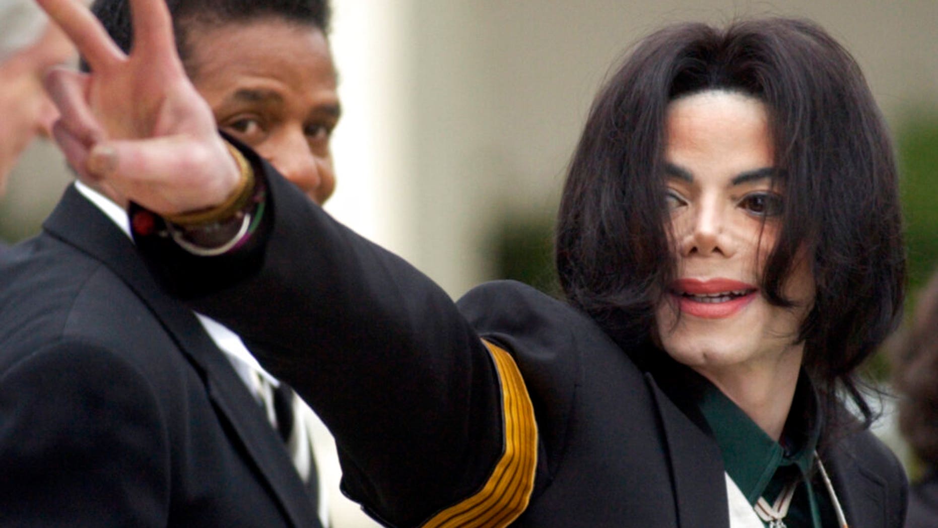 Michael Jackson beckons to his supporters as he shows up at the Santa Barbara County Superior Court in Santa Maria, California, on March 2, 2005, for his pedophile trial. (Associated Press)