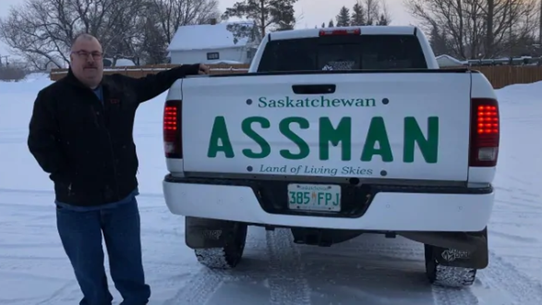 David Assman standing next to his pickup truck with a decal bearing his last name.