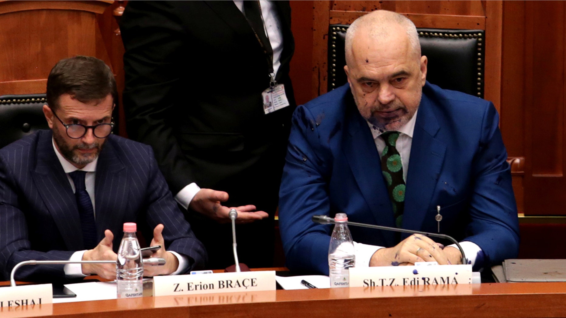 Albania's Prime Minister Edi Rama (right) looks on after liquid substance was thrown at him by members of the opposition during parliamentary session in Tirana, Albania, February 14, 2019.