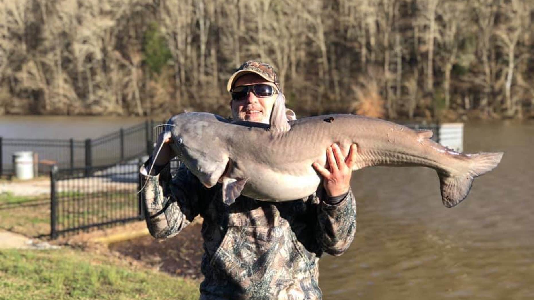 John Williams snagged the blue catfish in a 47-acre lake in Normandy.