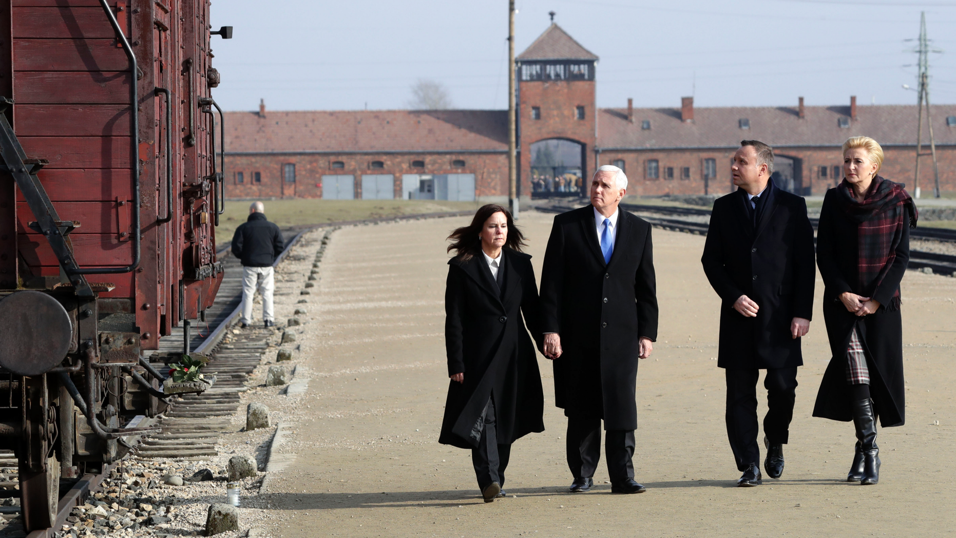 United States Vice President Mike Pence and his wife Karen Pence, left, walk with Poland's President Andrzej Duda and his wife Agata Kornhauser-Duda, right, during their visit at the Nazi concentration camp Auschwitz-Birkenau in Oswiecim, Poland, Friday, Feb. 15, 2019. (AP Photo/Michael Sohn)