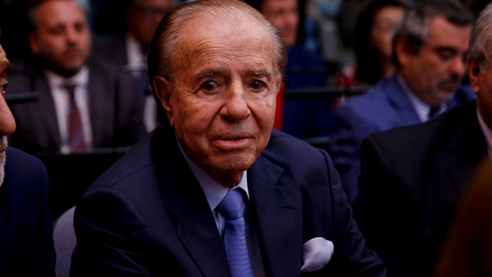 Former Argentine President Carlos Menem sits at a court house in Buenos Aires, Argentina, Thursday, Feb. 28, 2019. The court is expected to give its verdict on the trial against Menem, several former officials, a former federal judge and two former prosecutors, accused of hampering the investigation of the attack on a Jewish center in Buenos Aires in 1994. (AP Photo/Natacha Pisarenko)