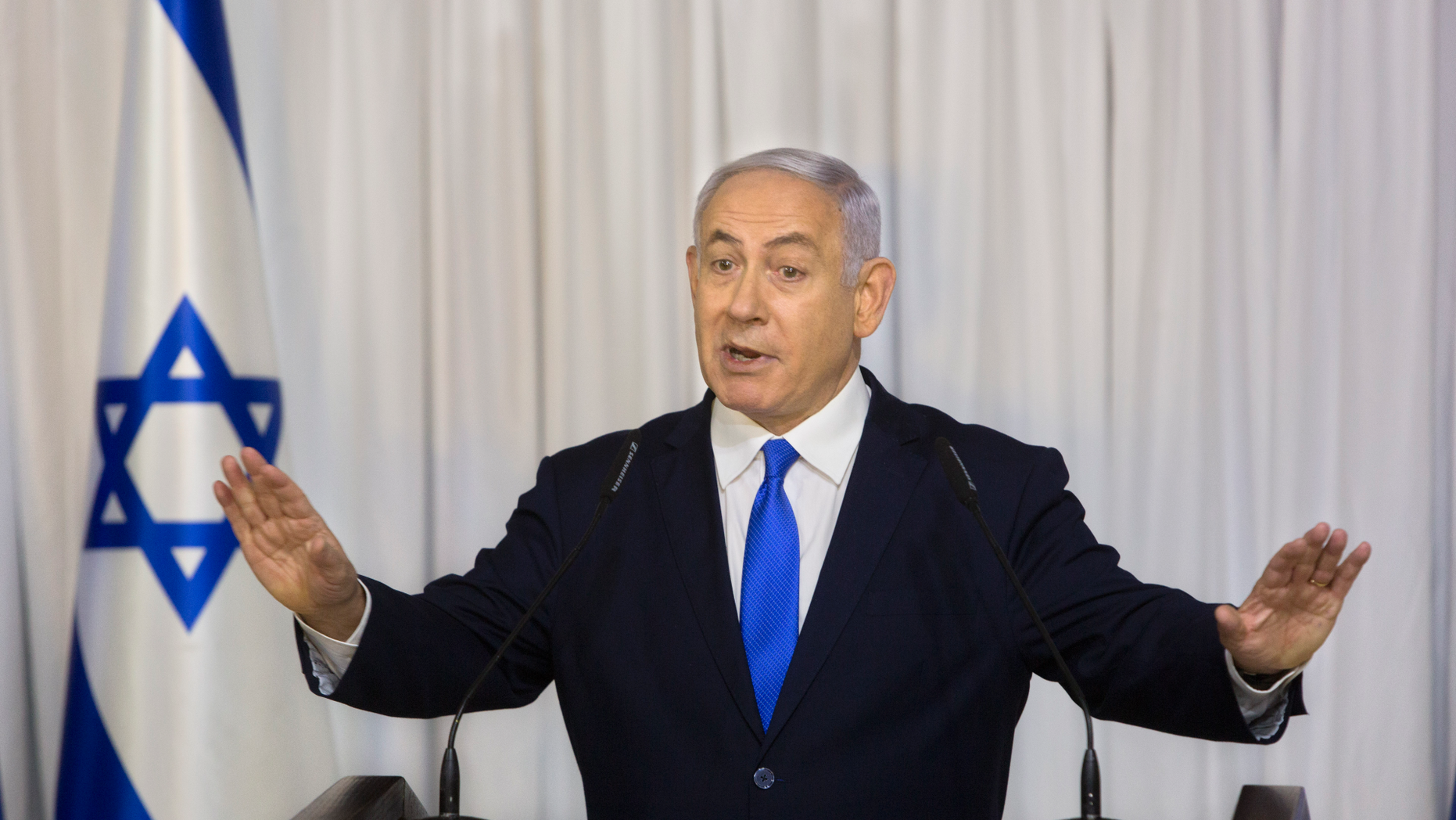 FILE - In this Thursday, Feb. 21, 2019 file photo, Israeli Prime Minister Benjamin Netanyahu delivers a statement in Ramat Gan, Israel. The attorney general's decision on whether to indict Netanyahu on a series of corruption allegations is expected to be delivered Thursday, Feb. 28, 2019. Avichai Mandelblit is expected to announce his decision after more than two years of intense investigations and deliberations. (AP Photo/Sebastian Scheiner, File)