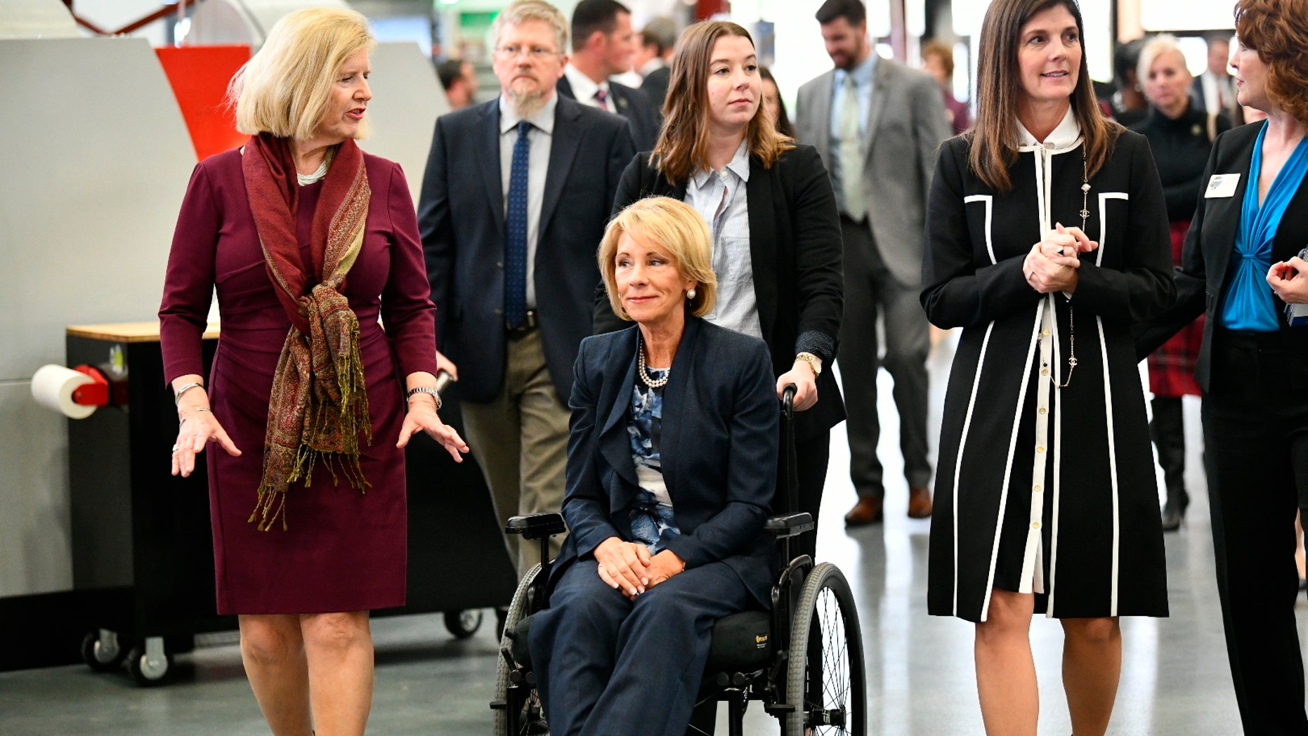 U.S. Secretary of Education Betsy DeVos, seated, tours a technical college in Florence, S.C., Thursday, Feb. 21, 2019, with state Education Superintendent Molly Spearman, left, and Lt. Gov. Pamela Evette, right. DeVos made a trip to the state to visit an area once known as the “Corridor of Shame” where officials say dramatic improvements have been made in schools since state officials took over their control last year. (AP Photo/Meg Kinnard)