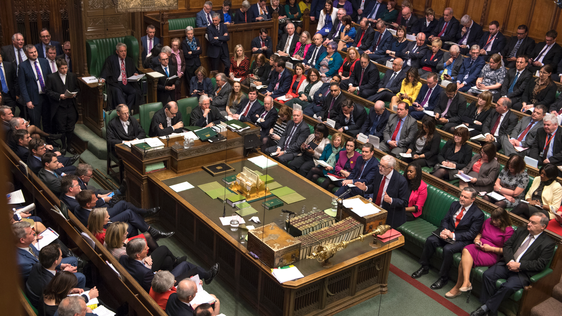 Britain's main opposition Labour Party leader Jeremy Corbyn, centre right, stands to talk to lawmakers inside parliament, London, Wednesday Feb. 27, 2019. Prime Minister Theresa May insisted Wednesday that Britain will leave the European Union on schedule next month, amid signs that her promise to give Parliament a vote on delaying Brexit was boosting support for her unpopular EU divorce deal. (Mark Duffy/UK Parliament via AP)