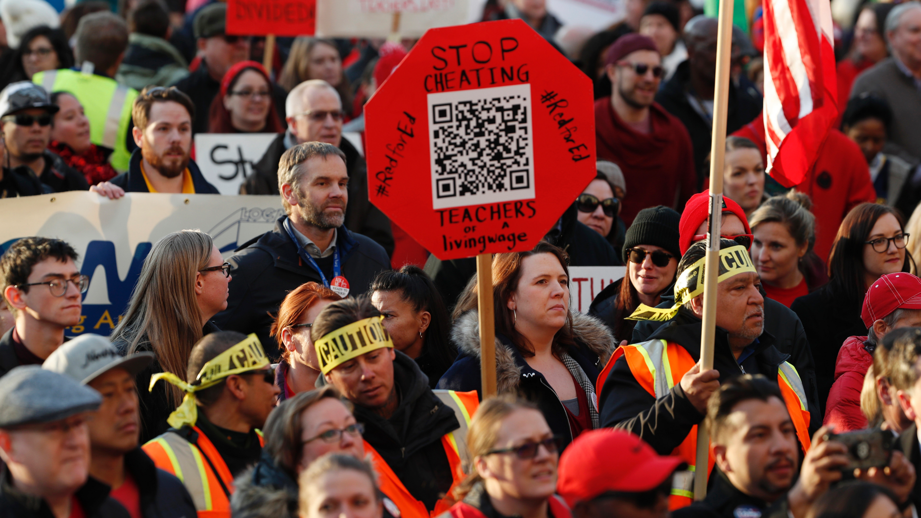 FILE - In this Jan. 30, 2019, file photo, Denver Public Schools teachers rally outside the State Capitol in Denver. Denver teachers are planning to strike Monday, Feb. 11, 2019 after failed negotiations with the school district over base pay. (AP Photo/David Zalubowski, File)