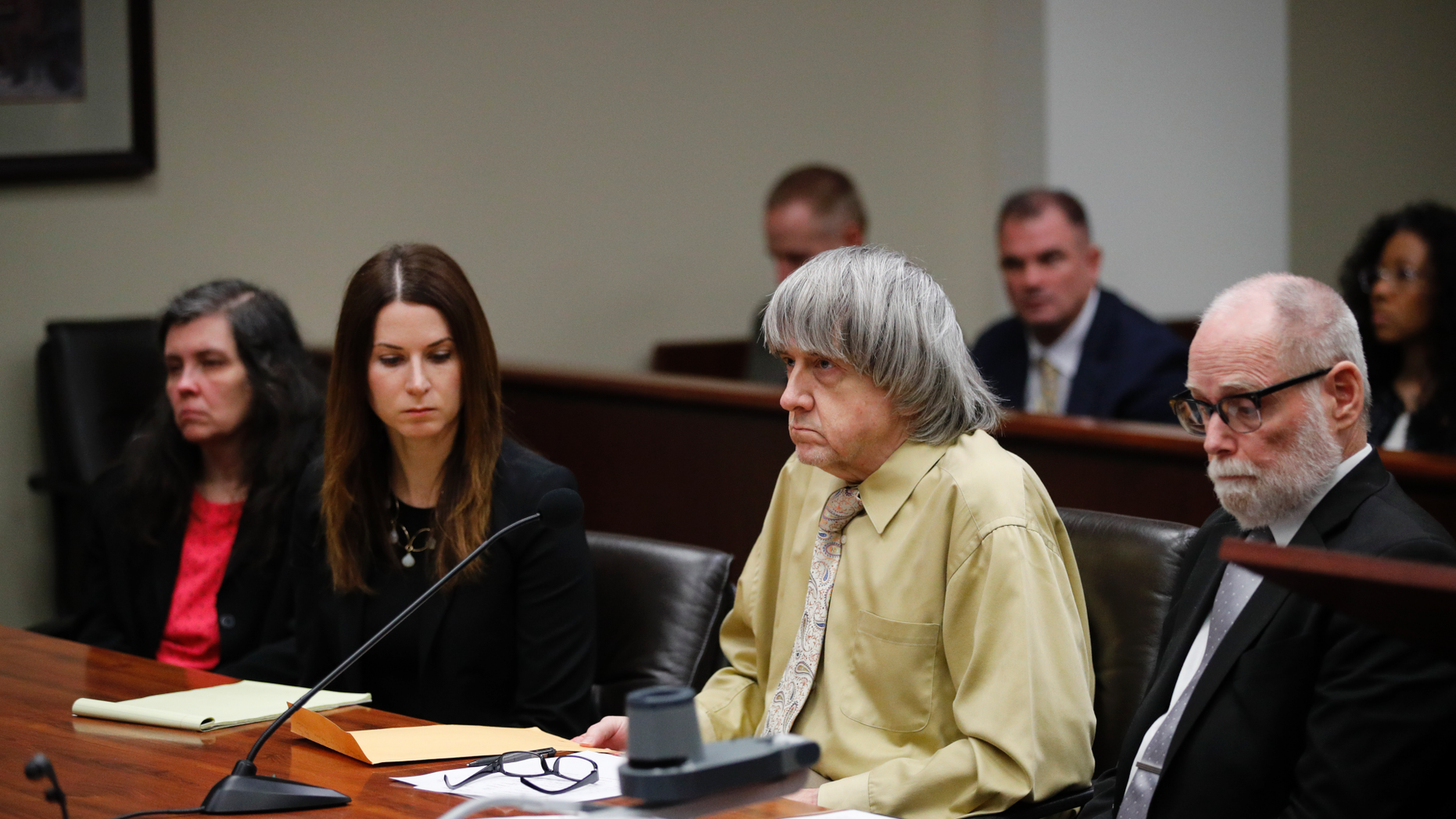 David Turpin, second from right, and wife, Louise, far left, sit in a courtroom with their attorneys, Allison Lowe, second from left, and David Macher Friday, Feb. 22, 2019, in Riverside, Calif. The California couple who shackled some of their 13 children to beds and starved them have pleaded guilty to torture and other abuse. (AP Photo/Jae C. Hong, Pool)