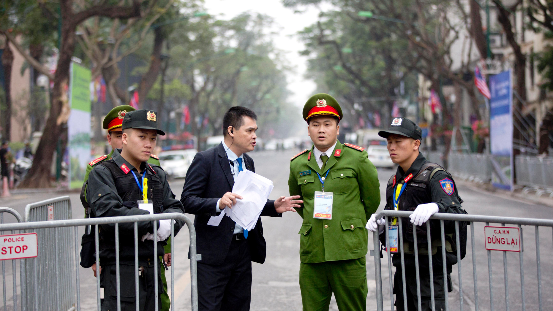 Security guards stand at a barricaded outside Melia Hotel where North Korean leader Kim Jong Un was expected to stay, in Hanoi, Vietnam, Tuesday, Feb. 26, 2019. Kim arrived in Vietnam Tuesday for his second summit with U.S. President Donald Trump. (AP Photo/Gemunu Amarasinghe)